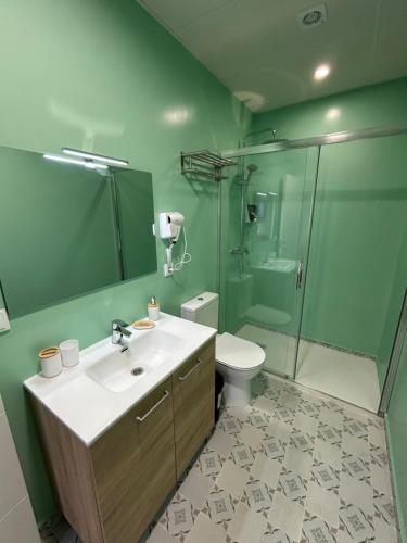 a bathroom with a sink and a toilet and a shower at Casa Cuatro Esquinas in Utrera