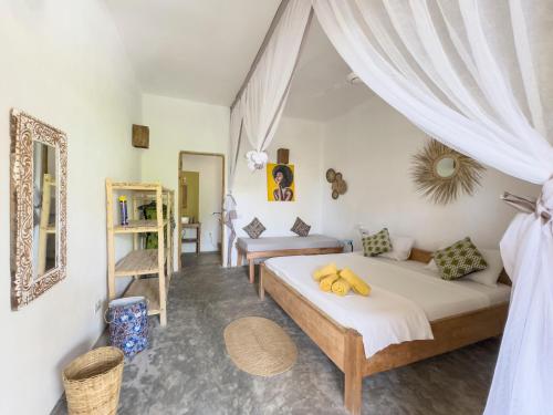 a bedroom with two beds in a room at BONDENI BEACH HOUSE in Jambiani