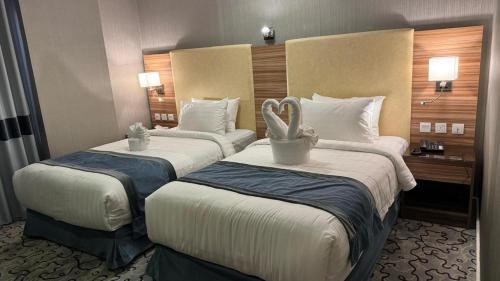 a hotel room with two beds with towels on them at فندق الشهباء الفيحاء Hotel Al Shahba Al Faiha Jeddah in Jeddah
