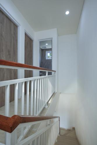 a staircase in a house with white walls at Opin Villa Nusa Dua in Nusa Dua