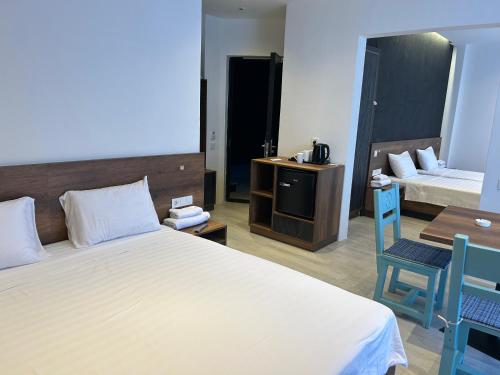 a hotel room with a bed and a desk and a bed at Chiko Group in Aspindza