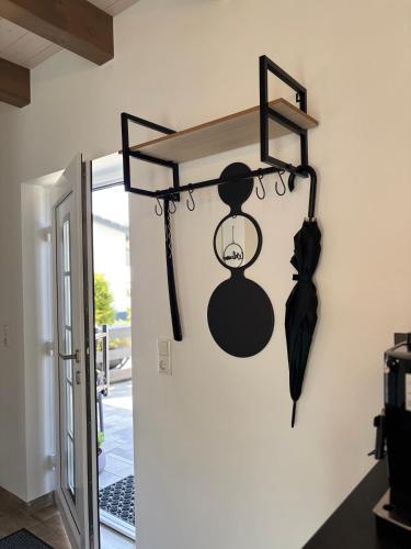 a rack with an umbrella hanging on a wall at Fichtelcube de in Schönwald