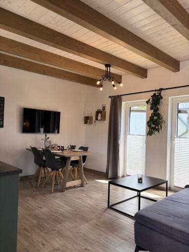 a living room with a table and a dining room at Fichtelcube de in Schönwald