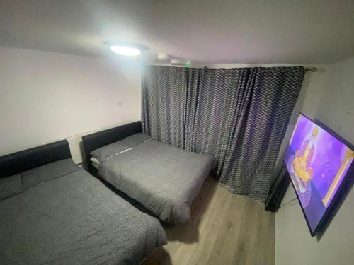 a small bedroom with a bed and a window at THE HEATHROW LODGE LONDON Uk in Harmondsworth