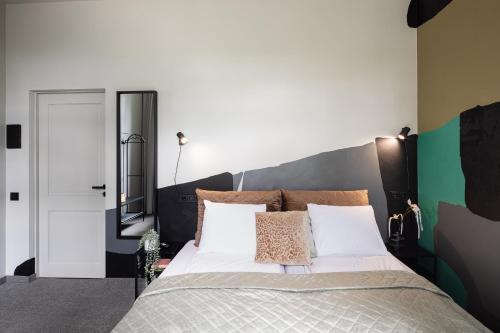 a bedroom with a large bed and a mirror at RixStay Apartments in Rīga