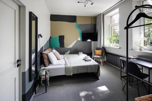 a bedroom with a bed and a desk in it at RixStay Apartments in Rīga