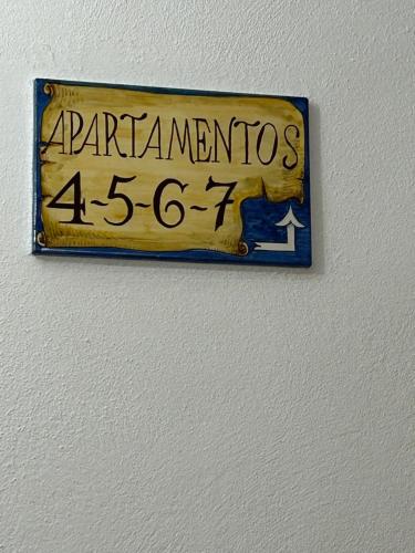 a sign on a wall that readsarracioninas crore at Casa Cuatro Esquinas in Utrera