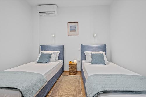 two beds sitting next to each other in a room at Central Beachfront Apt with a Breathtaking View! in Chalkida