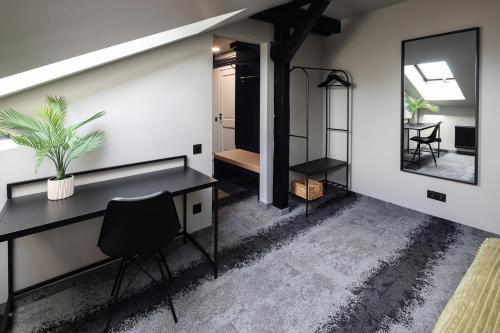 a home office with a desk and a mirror at RixStay Apartments in Rīga