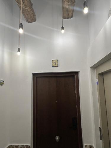a room with a door and lights on the ceiling at Casa Cuatro Esquinas in Utrera