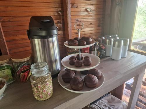 a counter with three plates of chocolate donuts on them at Tsakane Safari Camp in Hoedspruit