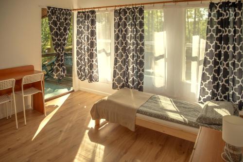 Una cama o camas en una habitación de Nova Mazury