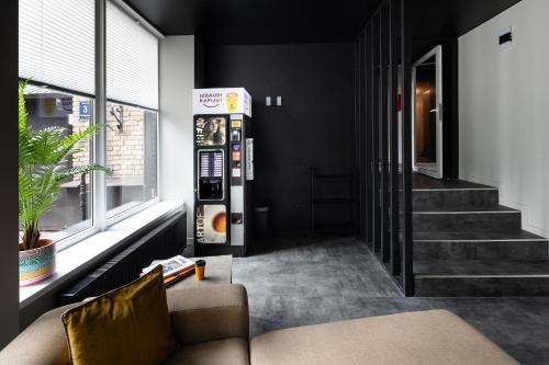 a living room with a couch and a vending machine at RixStay Apartments in Rīga