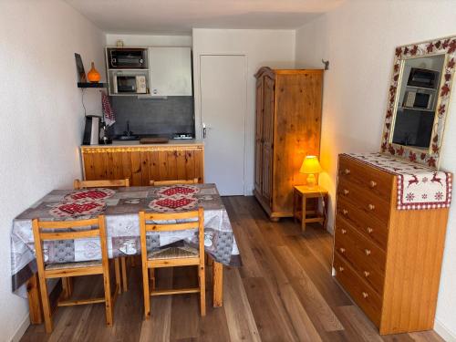 a kitchen with a table and chairs and a television at La Foux d Allos Studio résidence Les Étoiles in Allos