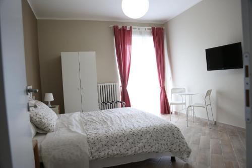 a bedroom with a bed and a table and a window at My Sweet Rome Guest House in Rome