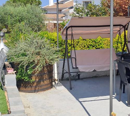 a gazebo with a table in a garden at Villa Andres in Sassari