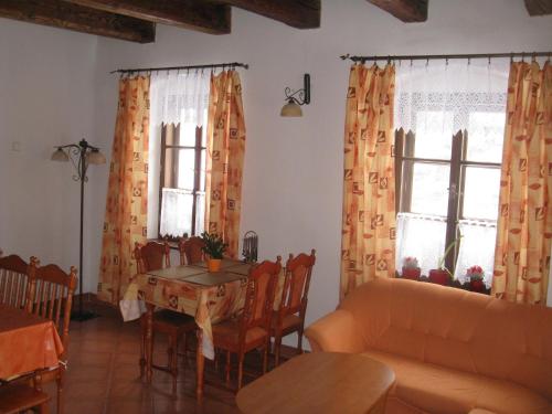 a living room with a table and chairs and windows at Holiday Home in Zátor near Ještěd Ski Resort in Zátor