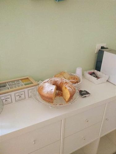 a counter with two loaves of bread on a table at Avia in Lucera