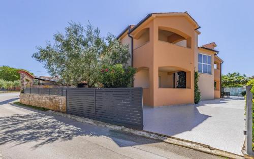 a house with a black gate in front of a street at Ferienhaus mit Privatpool für 13 Personen ca 192 qm in Peroj, Istrien Istrische Riviera in Peroj