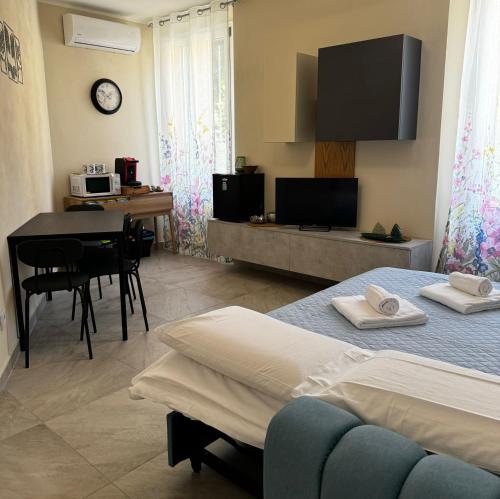 a bedroom with a bed and a desk and a table at Villa Patrizia affittacamere con parcheggio privato in Como