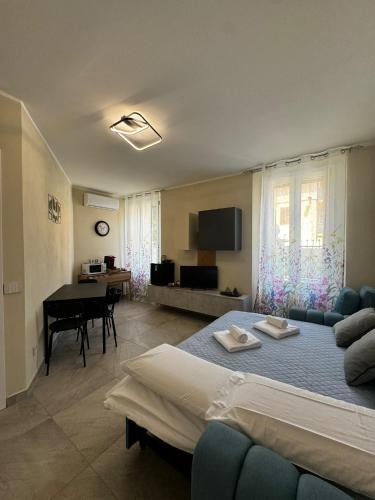 a living room with a bed and a couch and a piano at Villa Patrizia affittacamere con parcheggio privato in Como