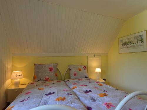 a bedroom with a bed with colorful sheets and pillows at Hellenthal Family Retreat in Hellenthal