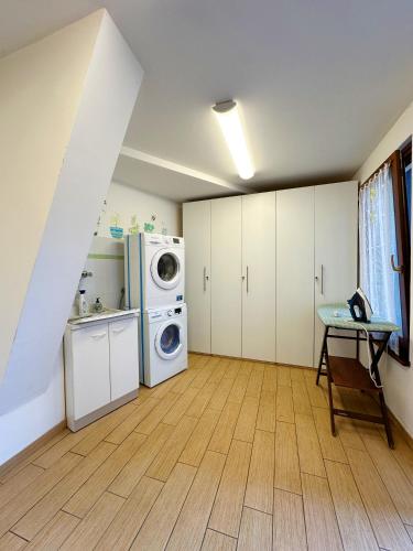 a laundry room with a washer and dryer at Casa Dorigoni Molveno in Molveno