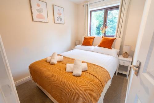 a bedroom with a large bed with towels on it at 2 Bed, Ground Floor Flat, Carlisle in Carlisle