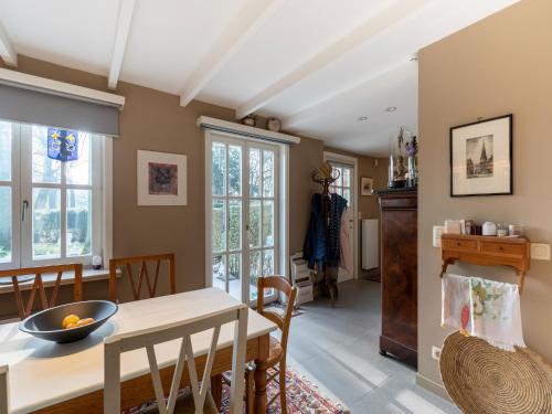 a kitchen and dining room with a table and chairs at Apartment in Kruibeke Wissekerke Castle in Kruibeke