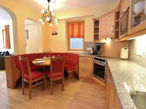 a kitchen with a table and chairs in a room at Chalet in Saalbach near Ski Lift in Saalbach Hinterglemm