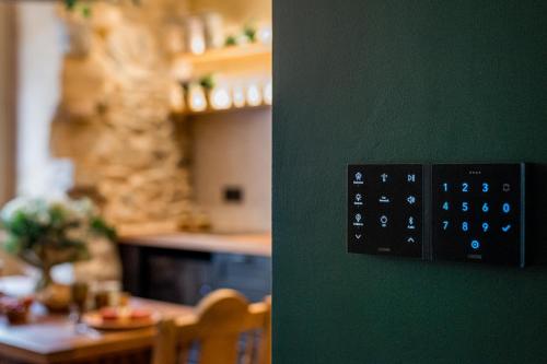 a lightswitch on a green wall in a dining room at La Maison de l'Apothicaire - Un refuge enchanté avec balnéo en hyper-centre in Crémieu