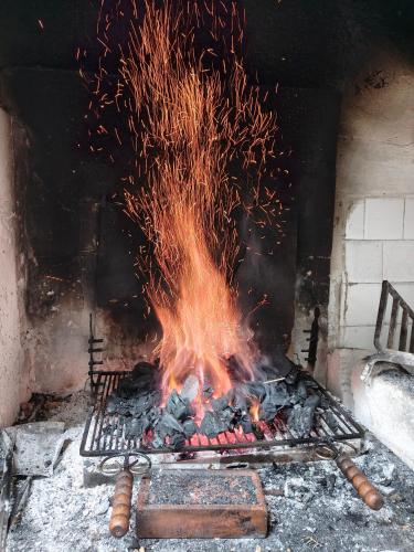 a fire in a brick oven with a bunch of sparks at Locanda di Bivigliano in Bivigliano