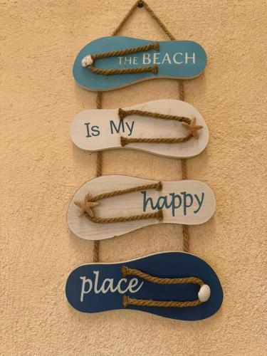 a sign that says the beach is my place and happy at Location d'un appartement in Tizouiar