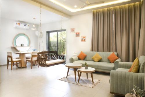 a living room with a couch and a table at Navkar Riviera Villa with Private Pool Surat-Navsari in Navsāri