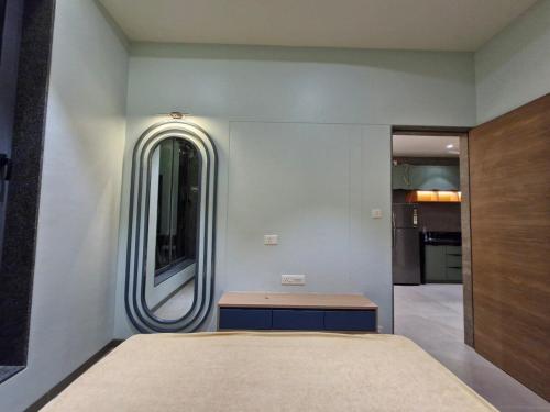 a bedroom with a large bed and a mirror at Navkar Riviera Villa with Private Pool Surat-Navsari in Navsāri