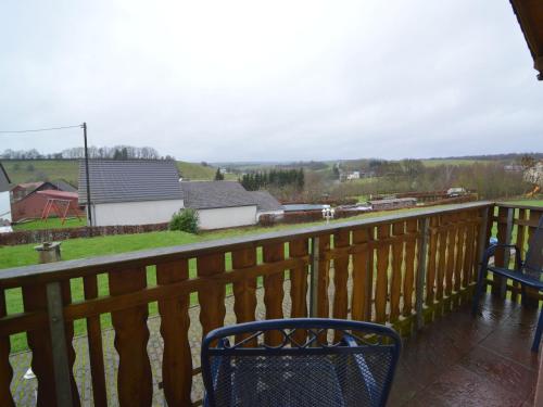 a balcony with two chairs and a view of a house at Apartment in Gransdorf with Scenic Views in Gransdorf