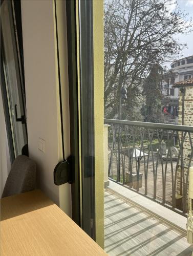 a view of a balcony from a room with a window at Hadri-rooms in Korçë