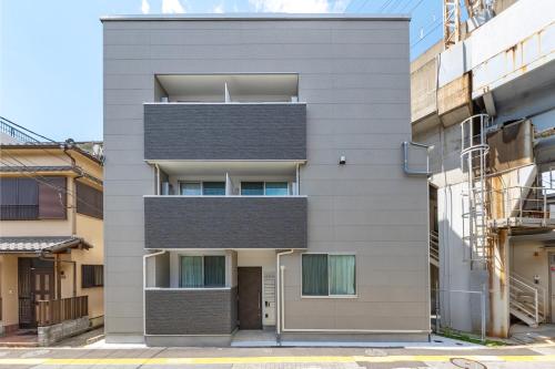 an apartment building with a grey facade at TRUSS 2nd in Tokyo