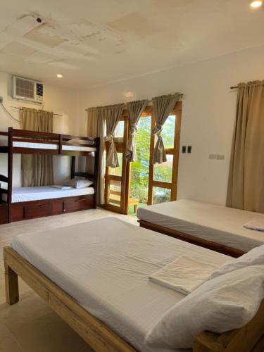 a bedroom with two bunk beds and a window at Private Villa in Lobo in Batangas City