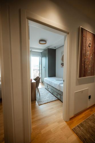 a view of a bedroom with a bed and a table at Apartman Boutique Arandjelovac in Arandjelovac