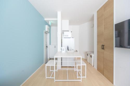 a kitchen with a white table in a room at TRUSS 2nd in Tokyo
