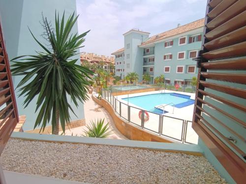 a view of a pool from the balcony of a apartment at Charming 3 Bedroom Apartment in Puerto Sotogrande in Torreguadiaro