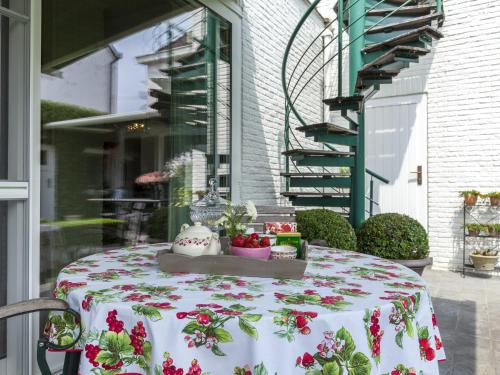 a table with a table cloth with flowers on it at House in Zingem near Hiking Trails in Zingem