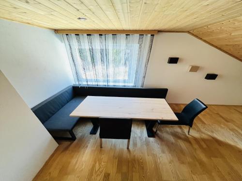 a table and chairs in a room with a window at Apartment in Salchau near Lachtal Ski Area in Salchau