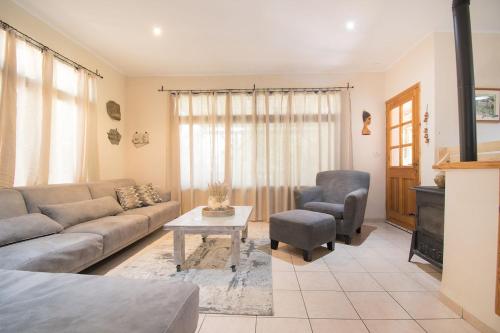 a living room with a couch and a table at וילה כפרית in Chorazim