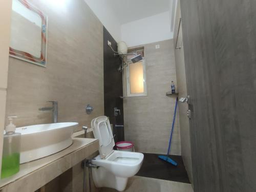 a bathroom with a white toilet and a sink at Sky line villa, Lonavla in Lonavala