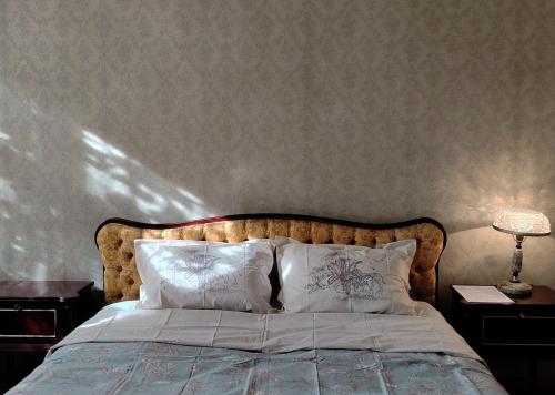 a bedroom with a bed with two tables and a lamp at Best place to stay in Lagodekhi in Lagodekhi