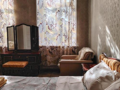 a bedroom with a mirror and a chair and a dresser at Best place to stay in Lagodekhi in Lagodekhi