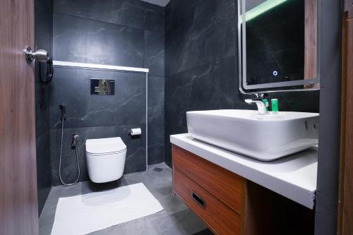 a bathroom with a sink and a toilet at Blue Moon Alleppey in Alleppey