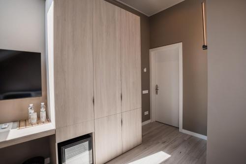 a living room with a fireplace and a cabinet at R.HOTEL in Chernivtsi